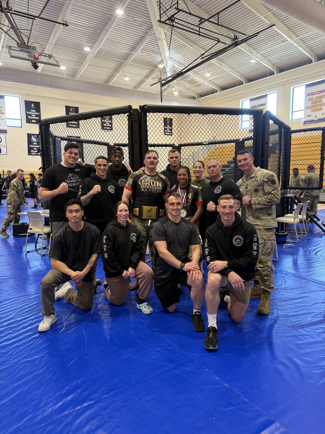 RCTA team in front of MMA cage with championship belt